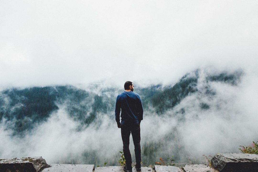 a-man-standing-on-top-of-the-mountain.jpg